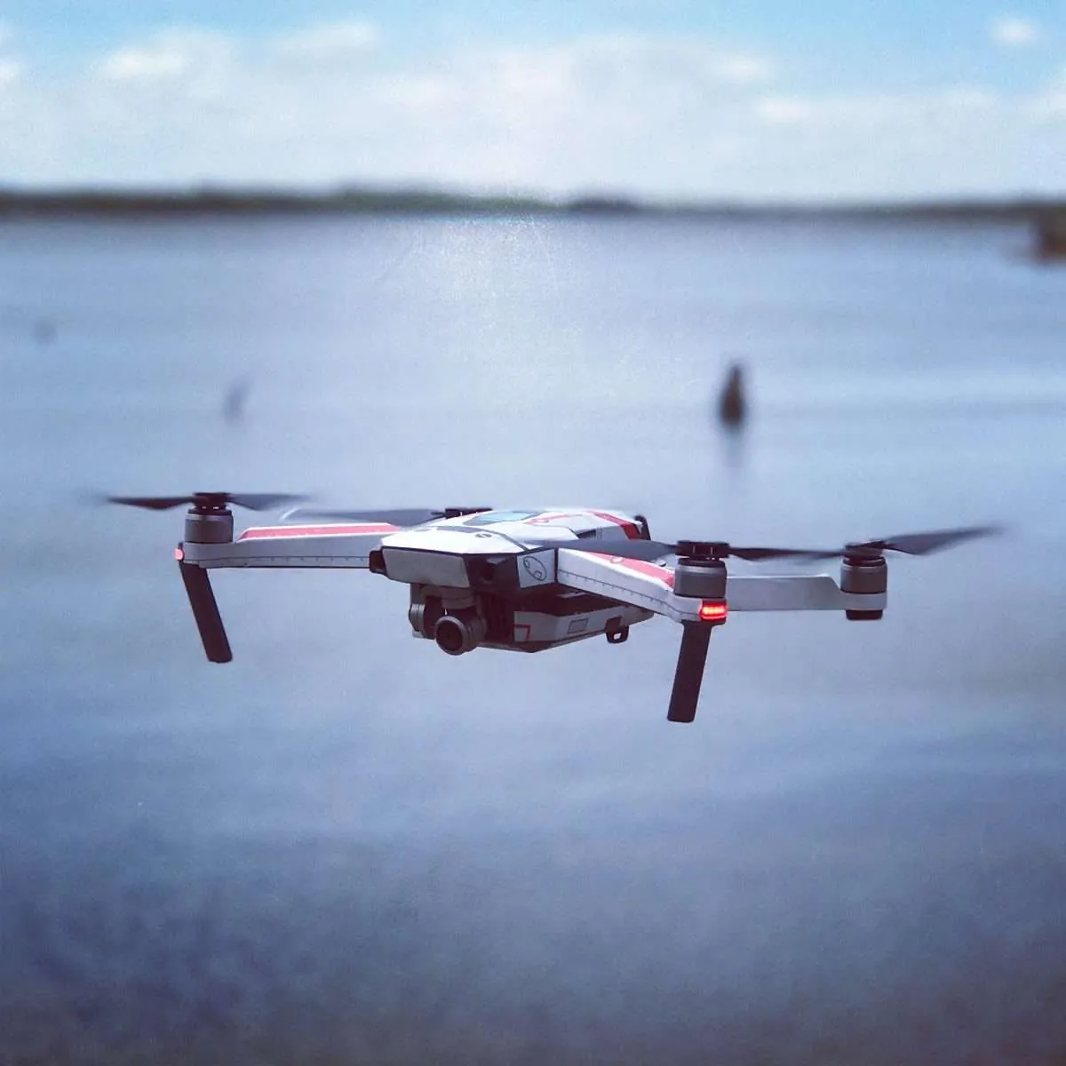 Camera drone hovering over water